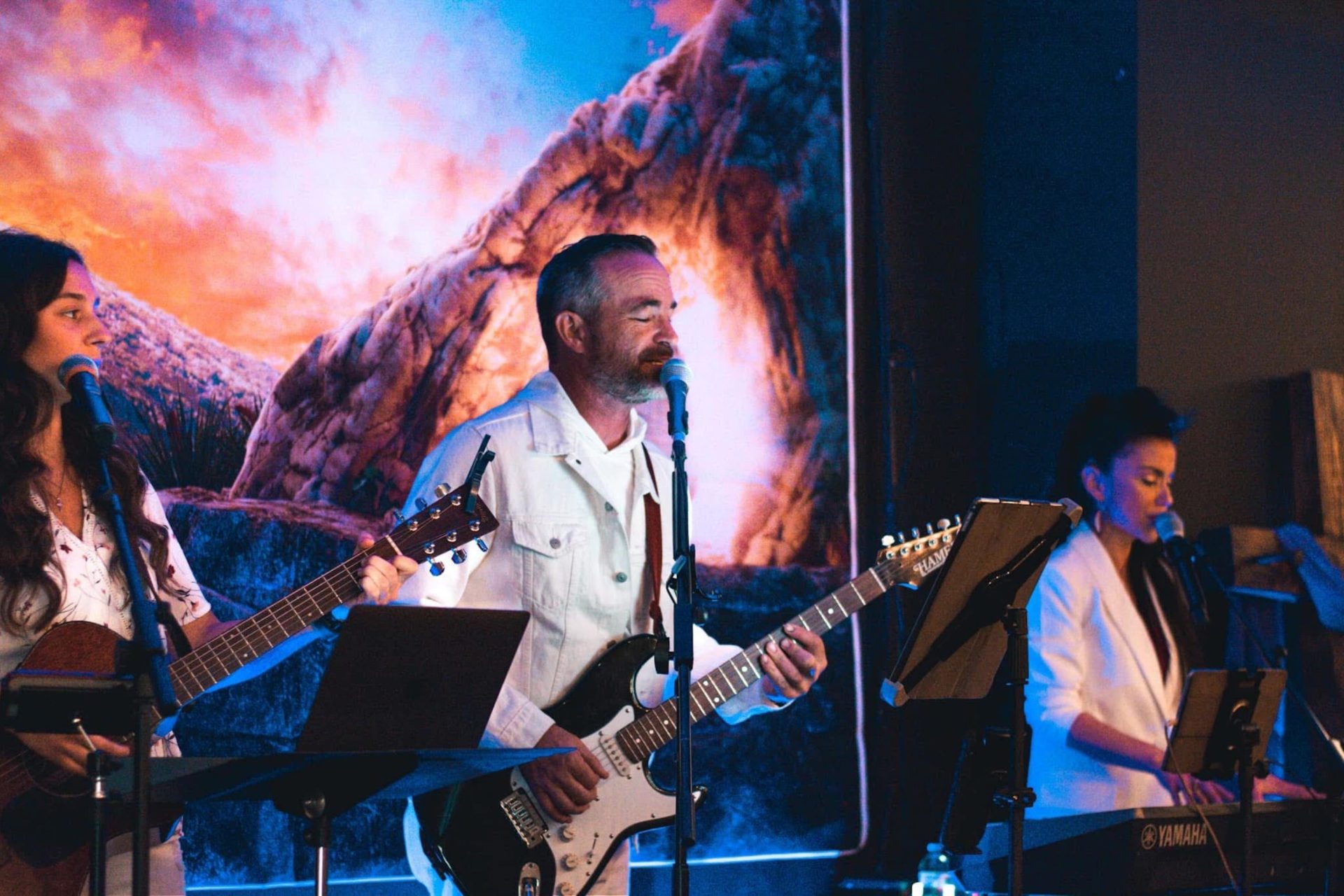 Worship Pastors Keith and Monica Barnett leading worship on guitar and keyboard